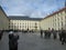 Tourists from different countries in the historical center of Prague, Czech Republic. On the right is a group of military.