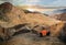 tourists discovering the famous golden canyon in death valley in california with manly beacon in the background