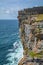 Tourists on Dun Aengus cliffs, Inishmore, Aran Islands, Ireland.