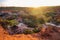 Tourists dwarfed by the rock formations at Marafa Depression - Hell's Kitchen at sunset in Malindi, Kenya