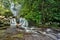 Tourists enjoy the charm of the Lubuk Black waterfall, bungus padang west sumatera indonesia