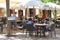 Tourists enjoy and chill at a cosy cafe terrace at the isle of Mallorca, Spain