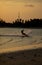 Tourists enjoy Kitesurfer surfing in the sea.