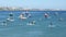 Tourists enjoy standup paddle - SUP at Cascais Bay, on a hot sunny day, Portugal