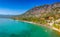 Tourists enjoy summer vacations swimming at Almyros beach in Kato verga seaside town near Kalamata, Greece