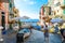 Tourists enjoy a sunny day on the Ligurian coast with the sea, cafe and boats in Riomaggiore Italy, on the Cinque Terre