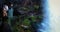 Tourists enjoy the view from behind the Dry Falls waterfall, tourist attraction in Nantahala National Forest, North Carolina. A tr