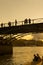 Tourists enjoy the warmth of spring, on a bridge of the Seine river in Paris.