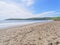 Tourists enjoying Aberdaron Beach in Wales on a late spring day