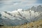 Tourists enjoying hike with beautiful views on Fee glacier on opposite side of valley above the Saas-Fee village in Switzerland