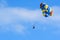 Tourists enjoying parasailing in a blue sky of Roatan, Honduras.