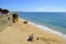 Tourists enjoying sunny weather on Armacao De Pera Beach on the Algarve coast