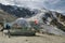 Tourists enjoying time in mountain bar with nice views on glacier in Hohsaas above the Saas-Grund village, Switzerland