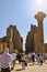 Tourists exploring Egypt. Travel tour group in Karnak Temple. Beautiful Egyptian landmark with hieroglyphics, decayed temples