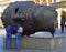 Tourists are exploring Head sculpture Eros Bendato by polish artist Igor Mitoraj on Market Square in Krakow, Poland