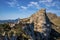 Tourists exploring rocky mountains against sky during summer vacation