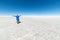 Tourists exploring the world famous Uyuni Salt Flat, among the most important travel destination in the Bolivian Andes. Wide angle