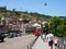 Tourists with families walk on the bridge in the center of old Tbilisi to see the sights. Georgia, Tbilisi - June 2019