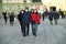 Tourists family walk downtown wearing mandatory protective mask