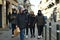 Tourists family walk downtown wearing mandatory protective mask