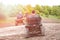 Tourists on a few quad bikes ride on rough terrain on a sunny day in the spring. Toned photo