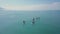 Tourists floating on SUP Board in blue sea. Clip. Top view of group of people on SUP-Boards floating in quiet clear sea