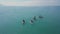 Tourists floating on SUP Board in blue sea. Clip. Top view of group of people on SUP-Boards floating in quiet clear sea