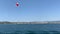 Tourists fly by parachute over the sea