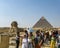 Tourists following a tour guide at Giza.