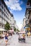 Tourists form all over the World walks among one of the main streets, Kartner Strasse in Vienna, Austria.