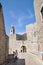 Tourists in front of the inner part of Ploce Gate, part of the town walls, with a view of the bell tower from the Dominican monast