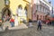 Tourists gather near a street musician performer playing violin in the Old Town center of Medieval Tallinn Estonia