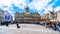 Tourists gathering around a street performer at the Dam square in the center of Amsterdam with the Royal Palace in the background