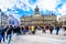 Tourists gathering at the Dam square the center of Amsterdam with the Royal Palace on the background