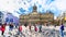 Tourists gathering at the Dam square with its many pigeons in the center of Amsterdam with the Royal Palace on the background