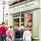 Tourists gaze at baked goods through a Paris bakery window