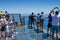 Tourists at the glass platform at the highest european cliff Cab