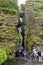 Tourists at Gljufrabui waterfall in Iceland