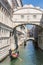 Tourists in gondolas sailing on the Rio de Palazzo o de Canonica Canal under the Bridge of Sighs or Ponte dei Sospiri in Venice