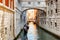 Tourists in gondolas sailing under the Bridge of Sighs, Venice