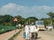 Tourists with guide approaching Queens Bath, Hampi, Karnataka, India