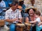 Tourists at Havana, mom and little daughter play with street musicians, Cuba