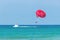 Tourists have fun, parachuting behind a boat, parasailing.