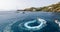 Tourists having fun on inflatable watercraft boat at the beautiful ocean of Greek island of Ios island, Cyclades, Greece.