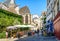 Tourists having lunch on the shady terrace of a restaurant in a small pedestrian cobbled street in Paris, France