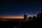 Tourists with headlamps at dawn waiting for sunrise at Pico del Teide mountain in El Teide National park. Tenerife, Canary Islands