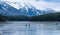 Tourists here doing ice-skating in Johnson Lake in winter. Banff National Park, Canadian Rockies.