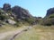 Tourists hikers walking in green meadow, bright spring morning, Sardinia, Italy