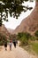 Tourists Hiking Through A Mountainous Gorge In Oman - March 2023