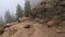 Tourists hiking at Roque Nublo point volcanic rock in Gran Canaria Island Spain